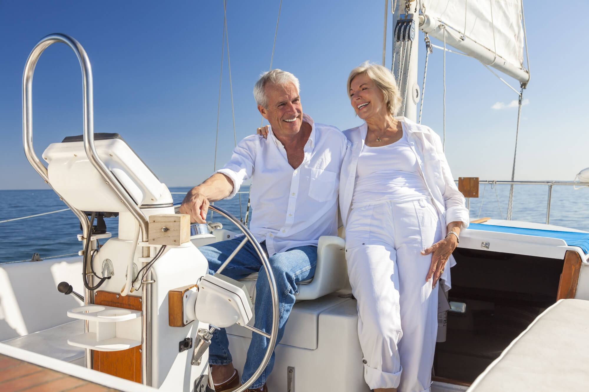 A happy senior couple laughing having fun sailing (1)