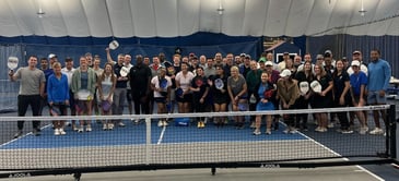 Pickleball players posing on a pickleball court