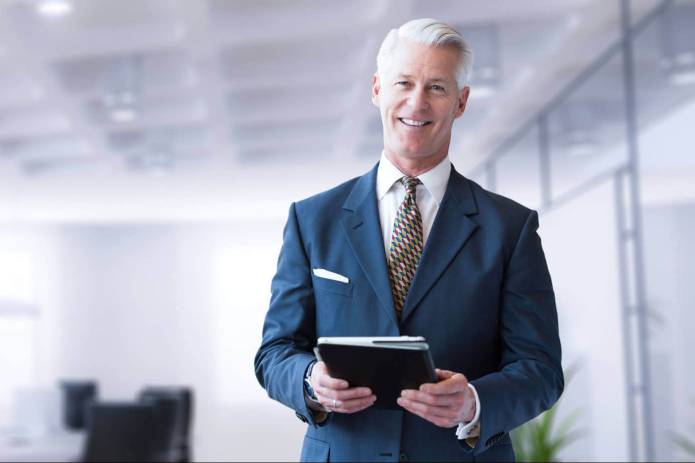 Portrait of senior businessman using tablet