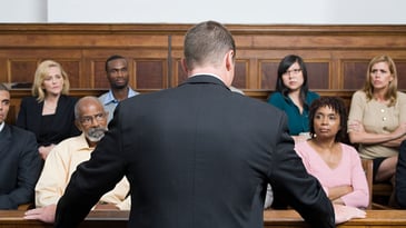 Lawyer looking at members of a jury in a courtroom