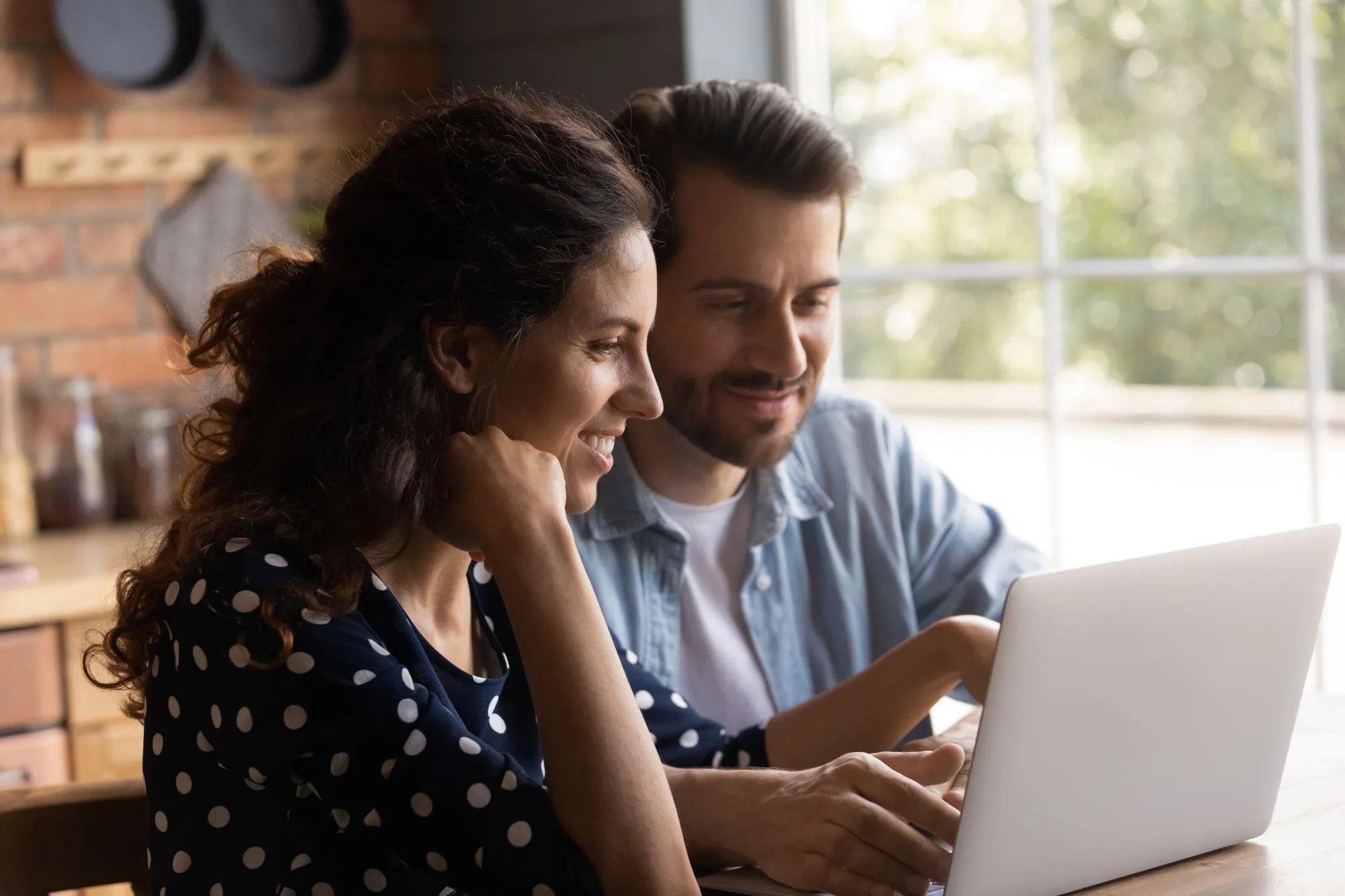 Young couple sitting with laptop