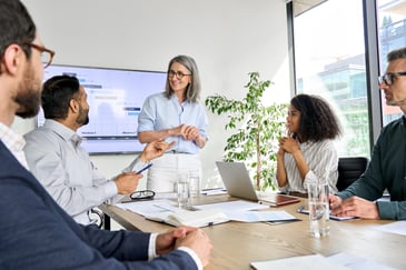 Executive speaks to company directors & officers in boardroom